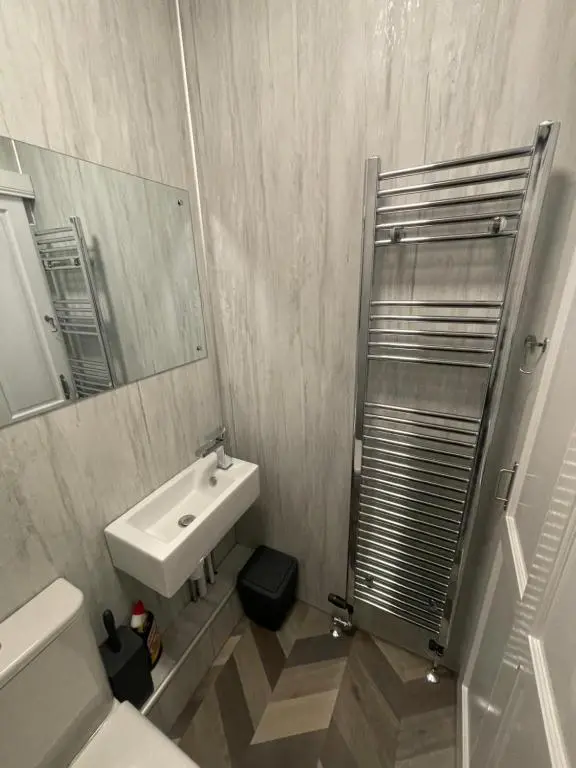 a bathroom with a sink and a mirror at Crown \u00e0ros beag, Ultra City Central 2 bedroom apartment with free parking onsite in Inverness