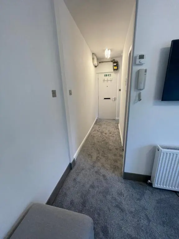 an empty room with a door and a hallway at Crown \u00e0ros beag, Ultra City Central 2 bedroom apartment with free parking onsite in Inverness