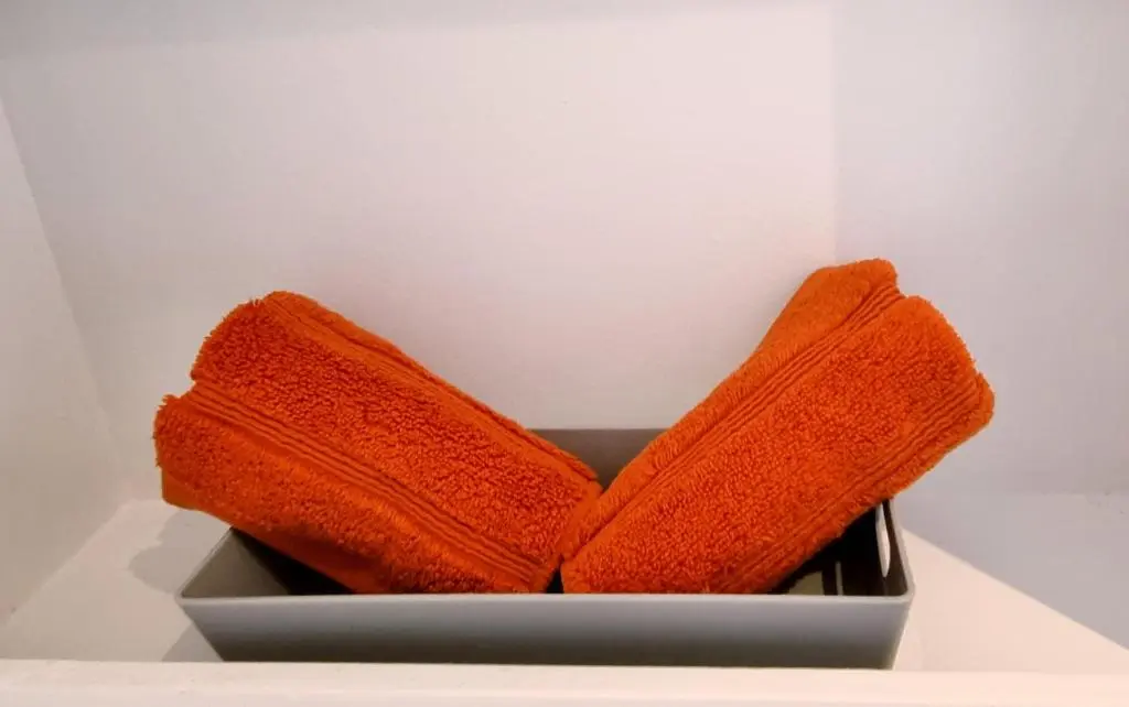 a gray box with orange towels in it at Bombie Glamping Pod in Grantown on Spey