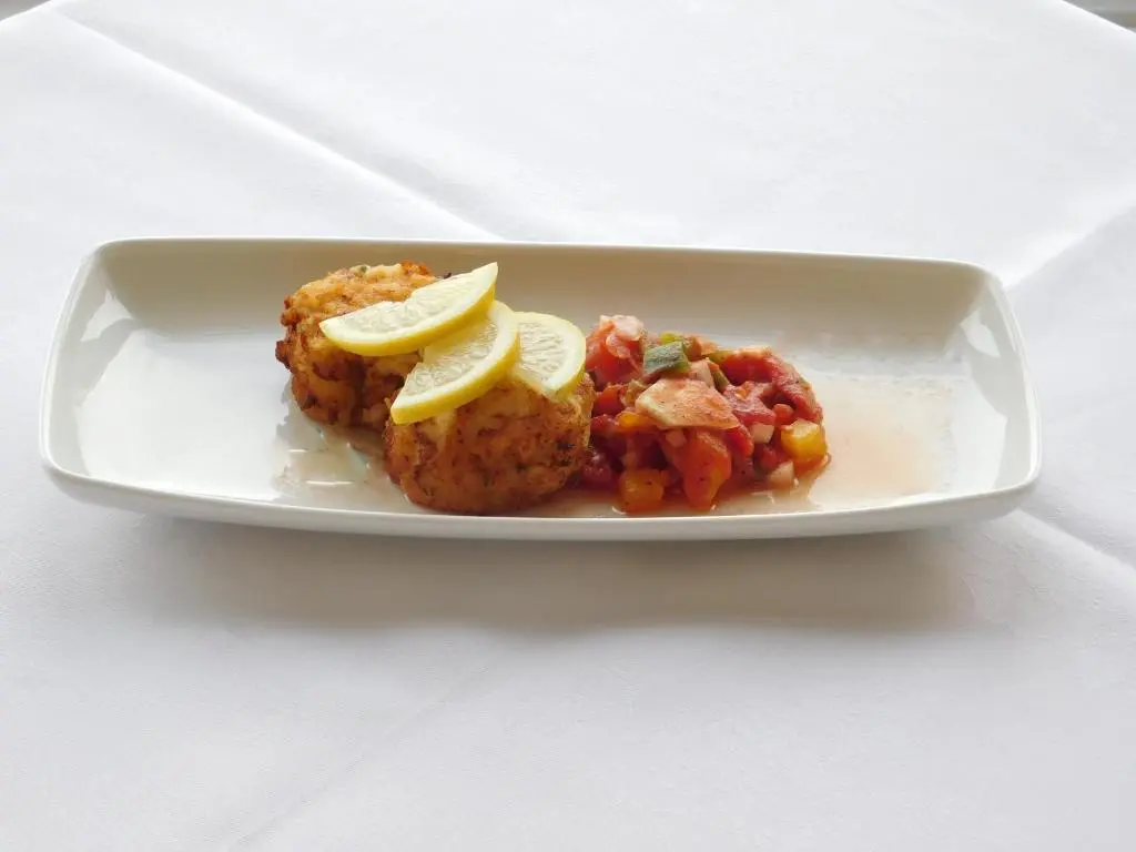 a styrofoam plate of food with meatballs with lemon slices at Cullen Bay Hotel in Cullen