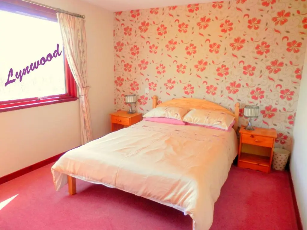 a small bedroom with a bed and a window at Cairngorm Highland Bungalows in Aviemore