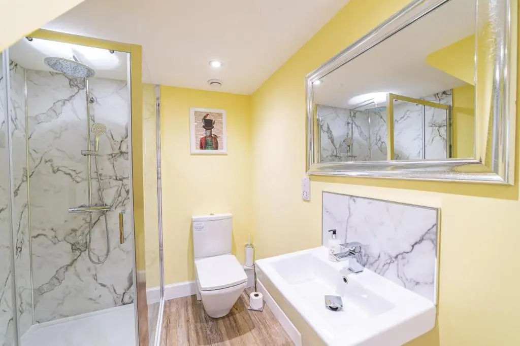 a bathroom with a sink and a shower and a toilet at Gardener\u2019s Cottage with Hot Tub in Blairgowrie