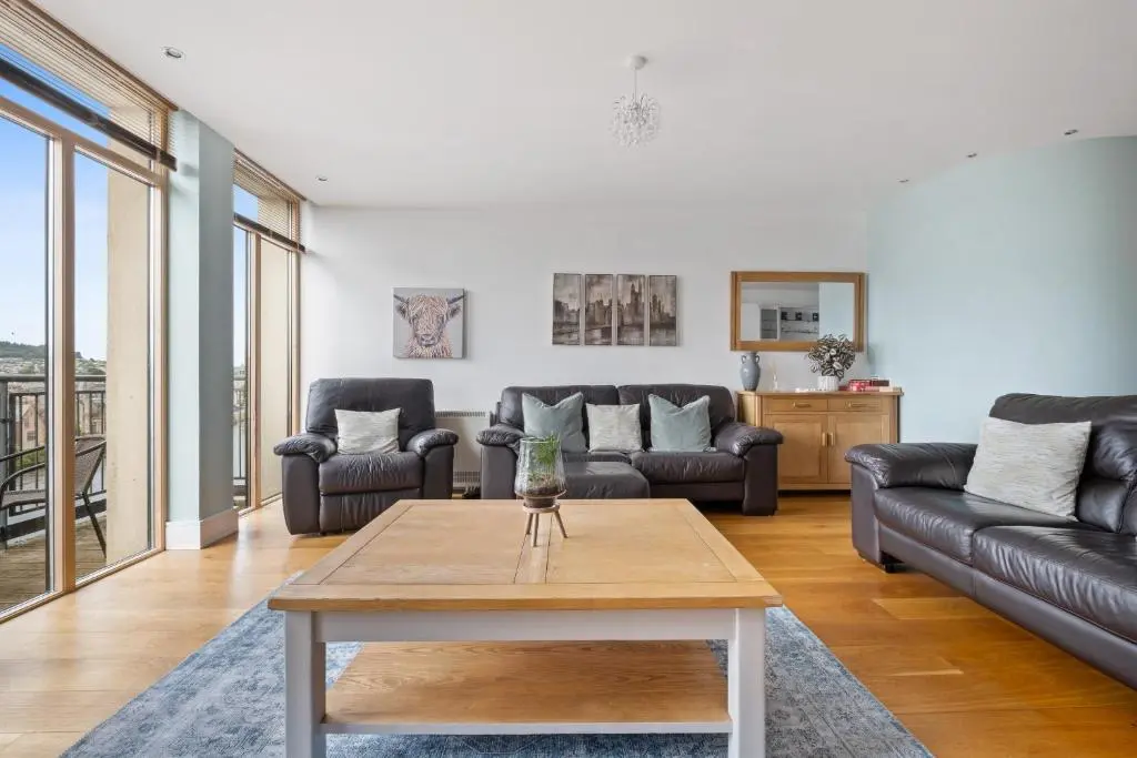 a living room with couches and a coffee table at By the Bridge by Toppo in Inverness
