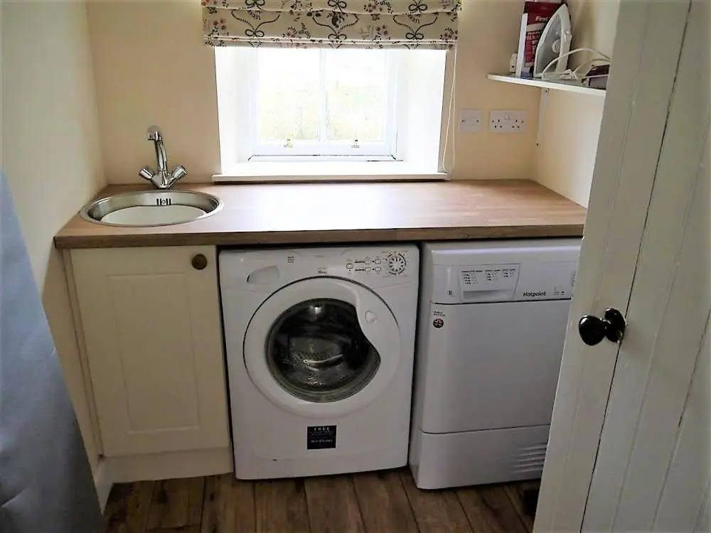 a kitchen with a washing machine and a sink at Bogroy in Aberlour