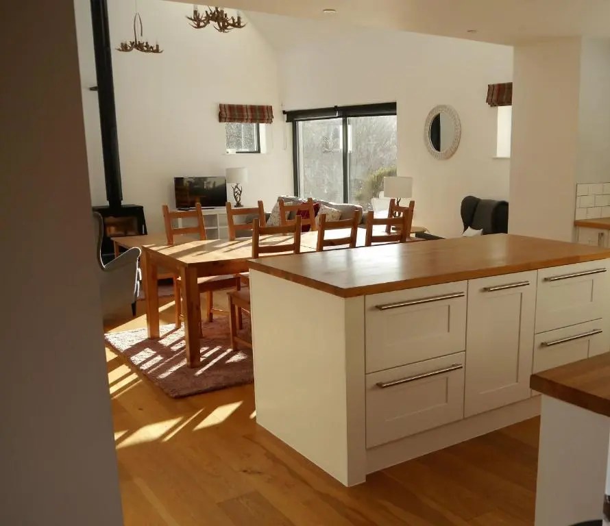 a kitchen and dining room with a table and chairs at Laundry Cottage in Aberlour
