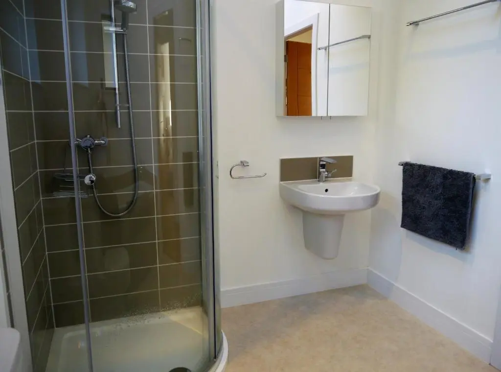 a bathroom with a shower and a sink at Laundry Cottage in Aberlour