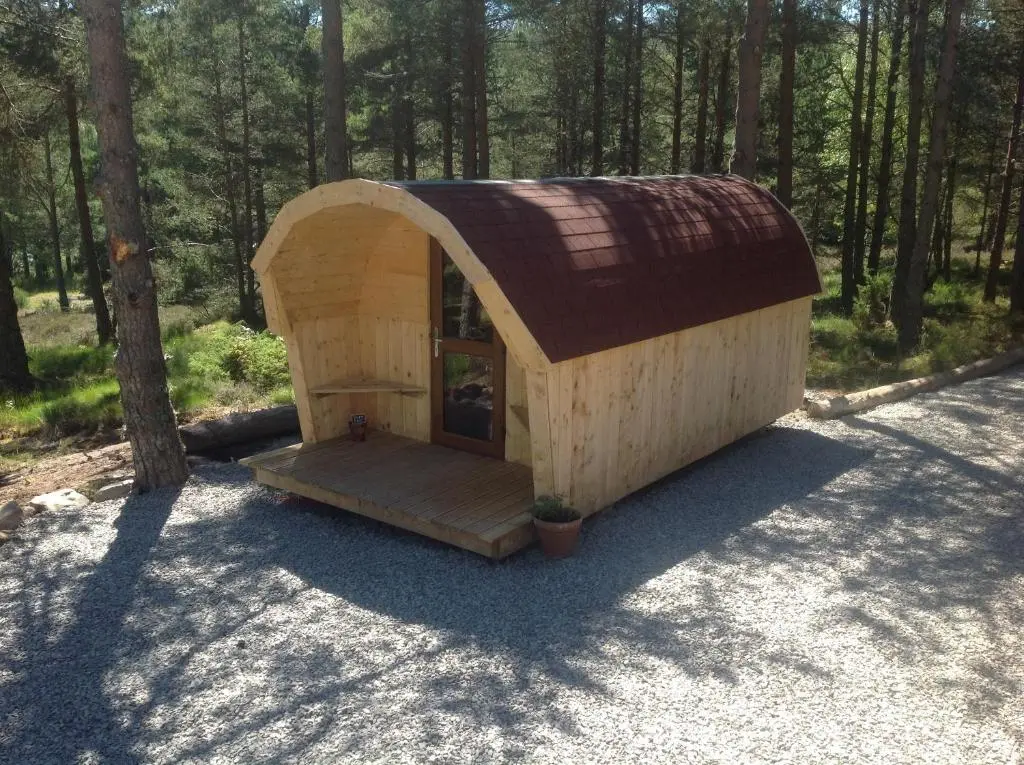 a small cabin in the middle of a forest at Camping Pod Heaven in Brackla