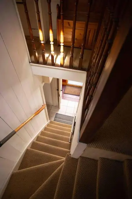 an overhead view of a staircase in a building at Loch Ness village cottage for 2 with free parking & pets welcome in Drumnadrochit