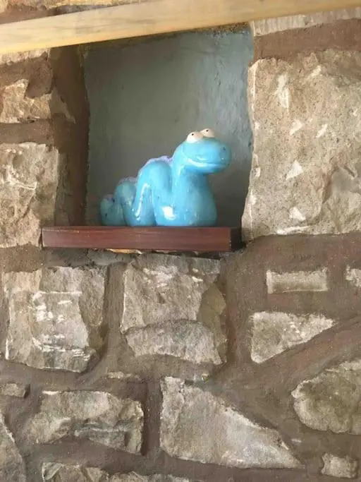 a blue toy sitting on a shelf in a stone wall at Loch Ness village cottage for 2 with free parking & pets welcome in Drumnadrochit