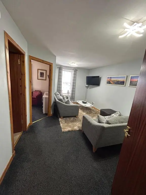 a living room with two couches and a television at Saint Blue Apartment in Tain