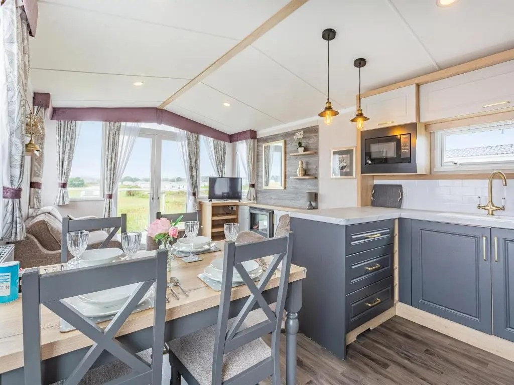 a kitchen and dining room with a table and chairs at The Bordeux in Dornoch