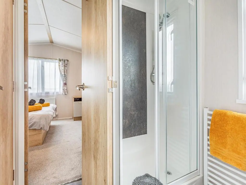 a room with a glass door leading to a bedroom at The Bordeux in Dornoch