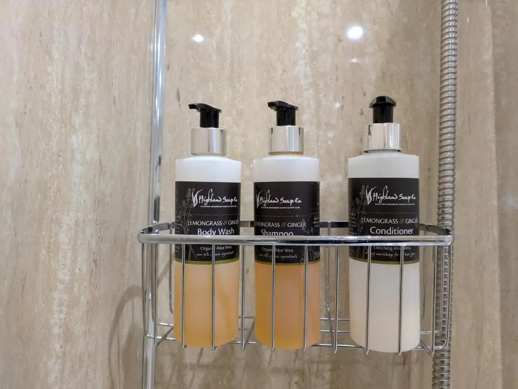 a group of three lotion bottles on a shelf at Craigmile Cottage in Fraserburgh
