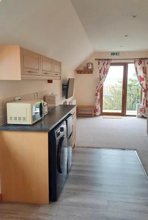 a kitchen with a microwave on a counter with a stove at Balormie View in Lossiemouth
