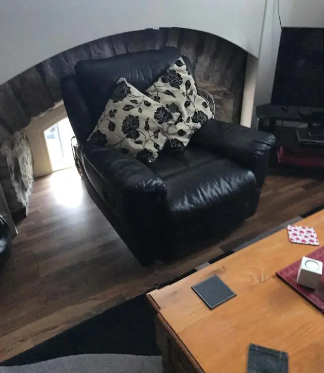 a black leather couch sitting in a living room at Scardroy Homes Inverness - Central 2 Bedroom with Parking WiFi Smart TVs Sleeps up to 6 in Inverness