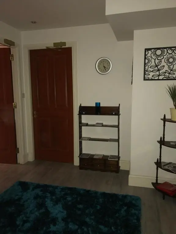 a living room with a door and a rug at Scardroy Homes Inverness - Central 2 Bedroom with Parking WiFi Smart TVs Sleeps up to 6 in Inverness