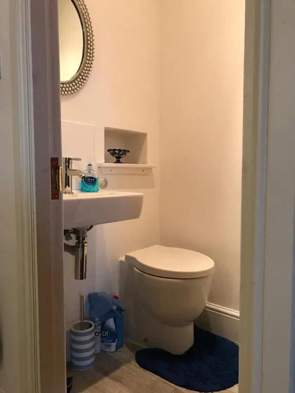 a bathroom with a toilet and a sink and a mirror at Scardroy Homes Inverness - Central 2 Bedroom with Parking WiFi Smart TVs Sleeps up to 6 in Inverness