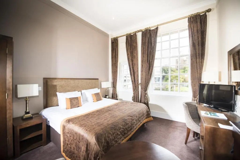 a hotel room with a bed and a television at Columba Hotel Inverness by Compass Hospitality in Inverness