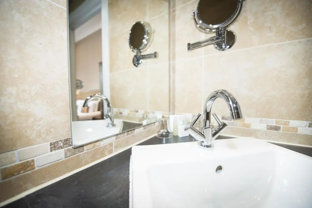 a bathroom with a sink and a mirror at Columba Hotel Inverness by Compass Hospitality in Inverness
