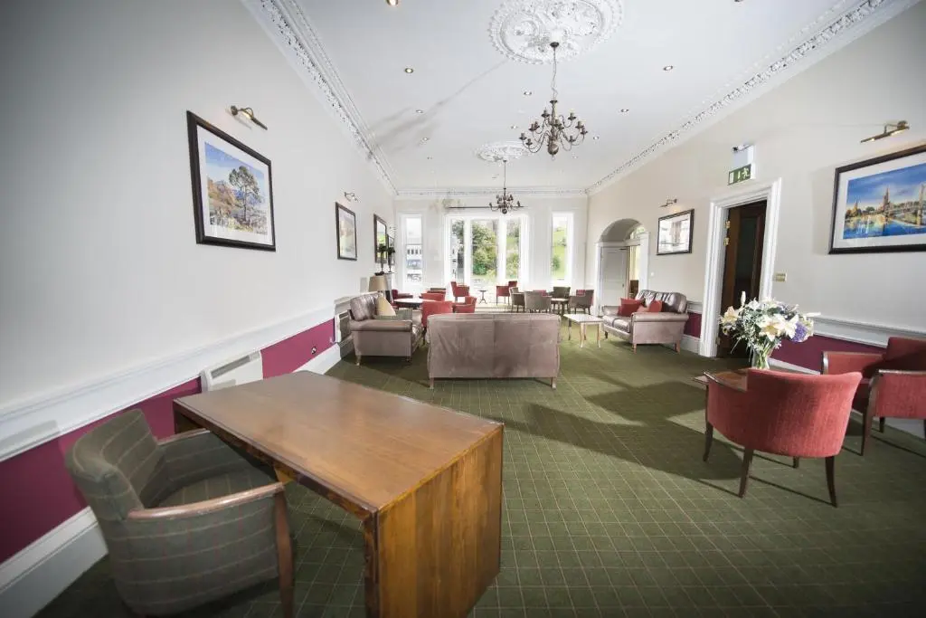 a waiting room with chairs and a table at Columba Hotel Inverness by Compass Hospitality in Inverness