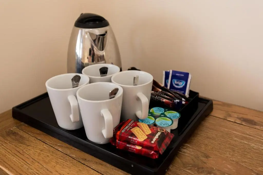 a tray with three cups and candy on a table at Craigmonie Hotel Inverness by Compass Hospitality in Inverness
