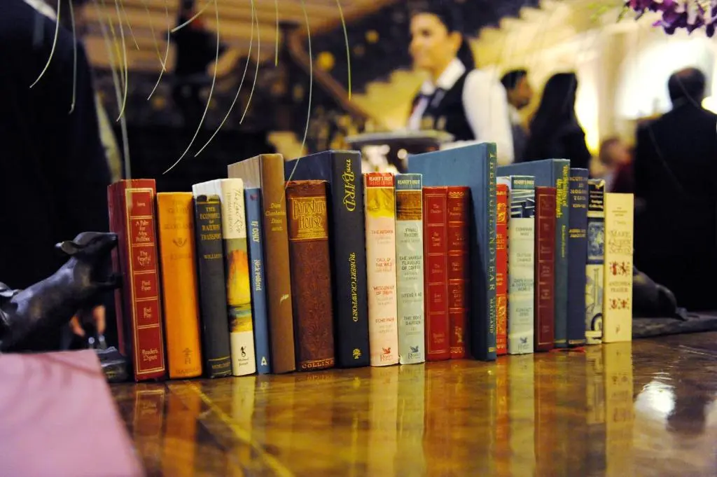 a row of books sitting on top of a table at The Royal Highland Hotel in Inverness