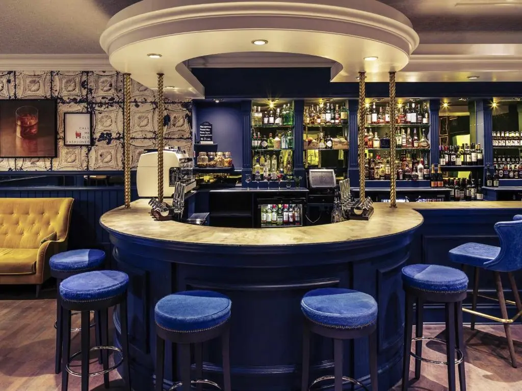 a bar in a restaurant with blue stools at Mercure Inverness Hotel in Inverness