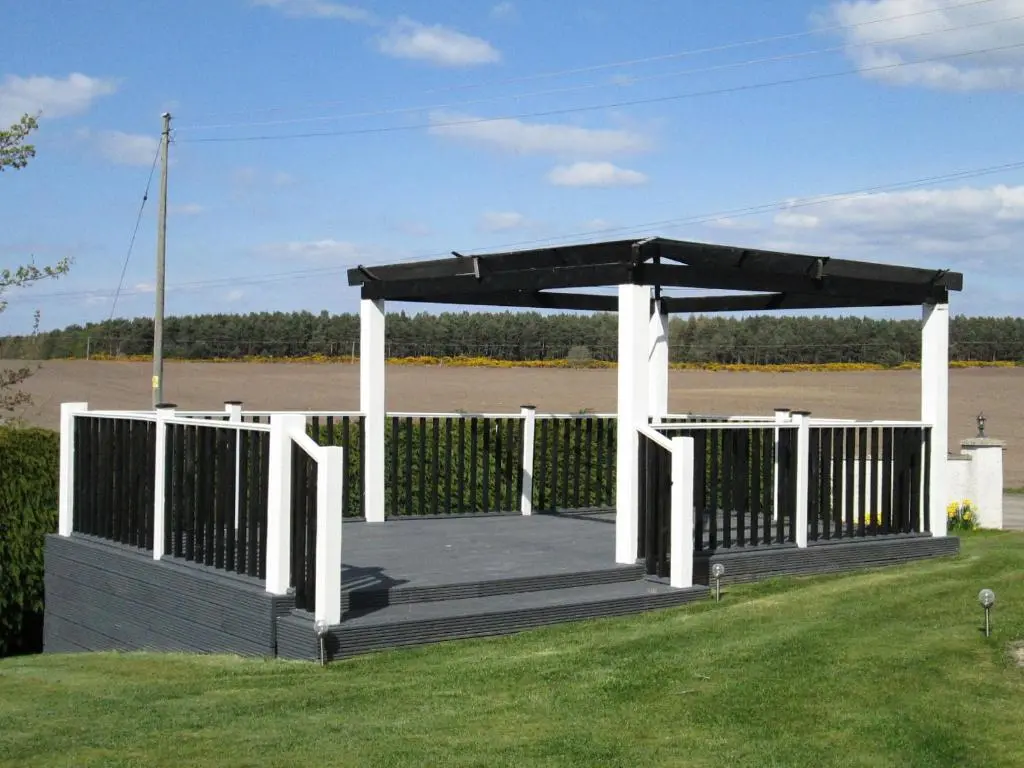 a gazebo in a field with a fence at Broomlea in Ardersier