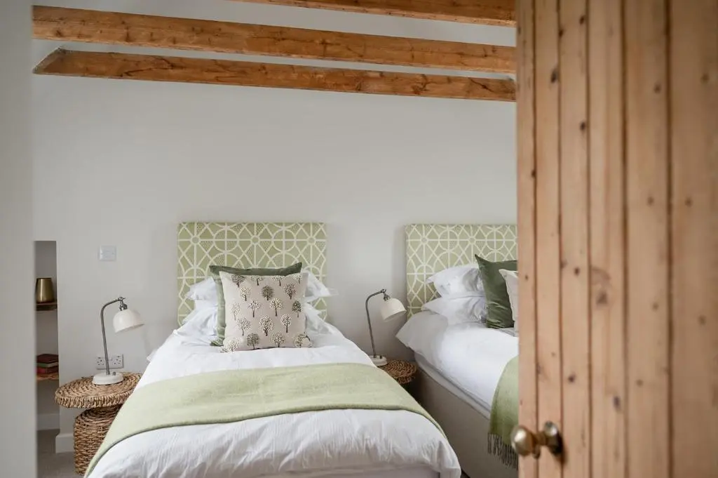a bedroom with two beds and two lamps at Beinn Cottage - Seasgair Lodges in Kincraig