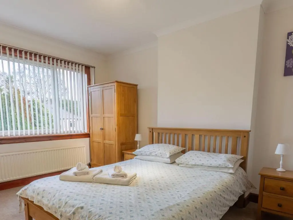 a bedroom with two towels on a bed at Holiday Home Beech by Interhome in Inverness