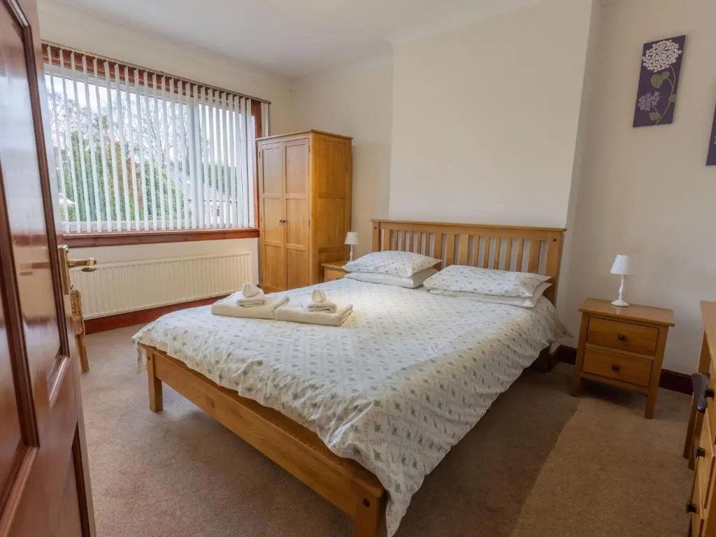 a bedroom with a bed with two towels on it at Holiday Home Beech by Interhome in Inverness