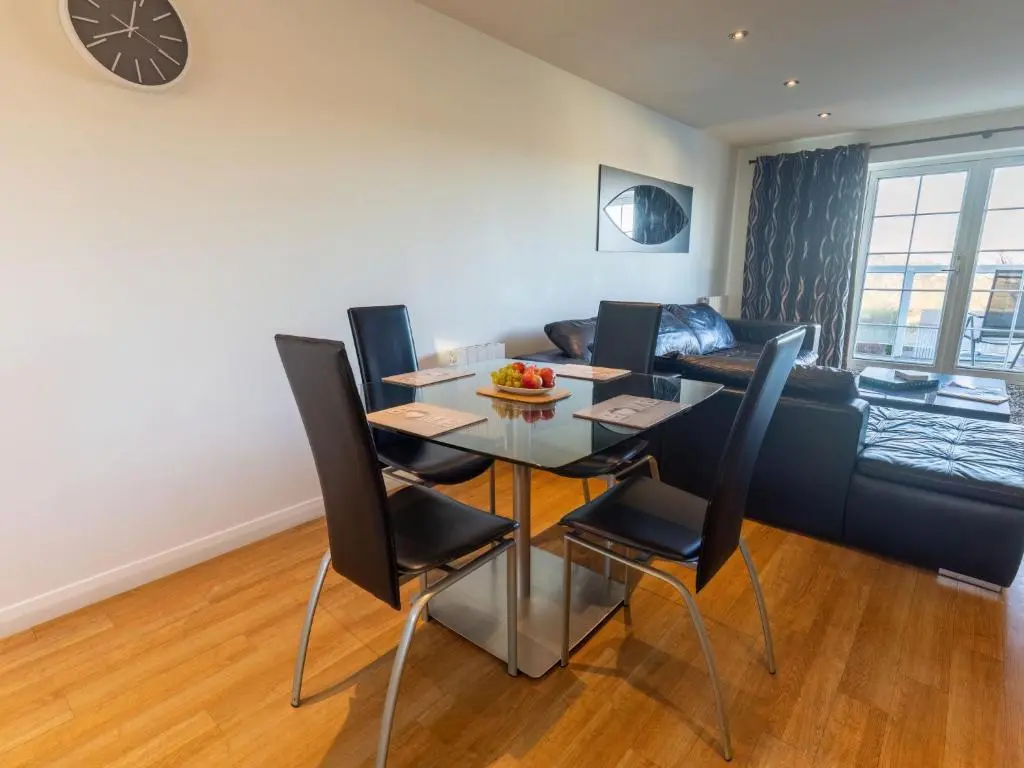 a living room with a table and chairs and a couch at Apartment Druid Temple by Interhome in Inverness