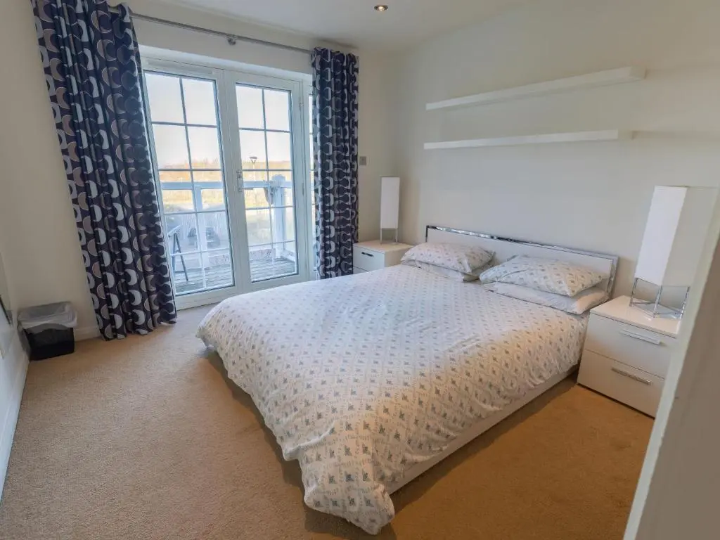 a bedroom with a bed and a large window at Apartment Druid Temple by Interhome in Inverness