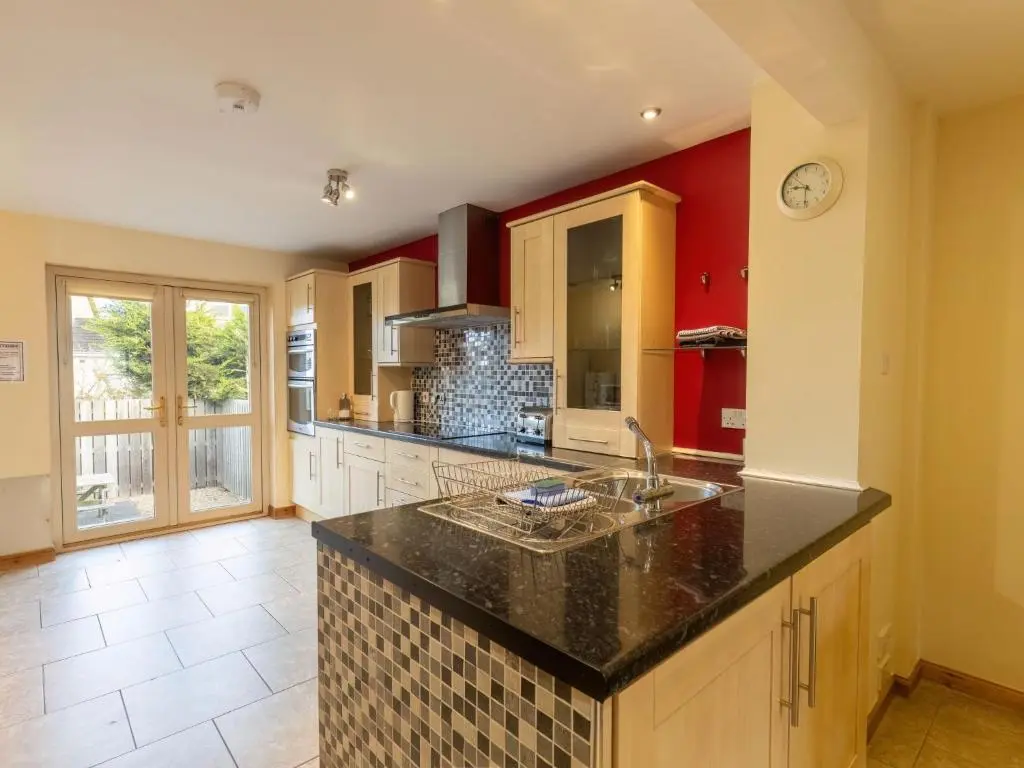 a kitchen with a sink and a counter top at Holiday Home Ardness Place by Interhome in Inverness