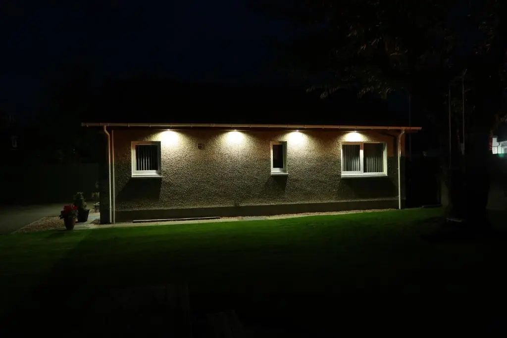 a house with lights on the side of it at night at Corunna Bed & Breakfast and Corunna Cottage in Inverness