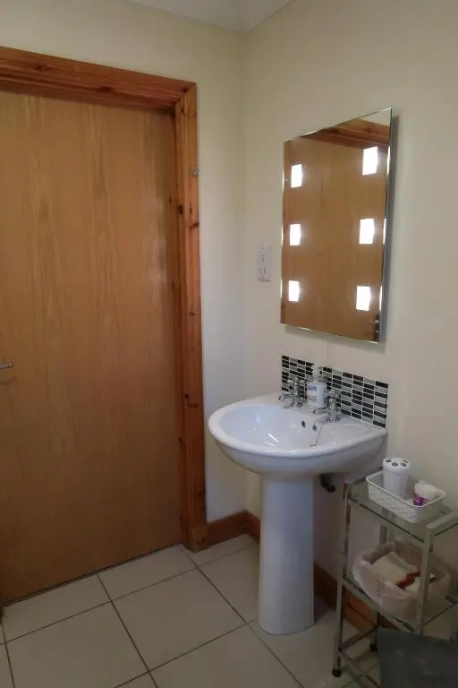a bathroom with a sink and a mirror at Corunna Bed & Breakfast and Corunna Cottage in Inverness