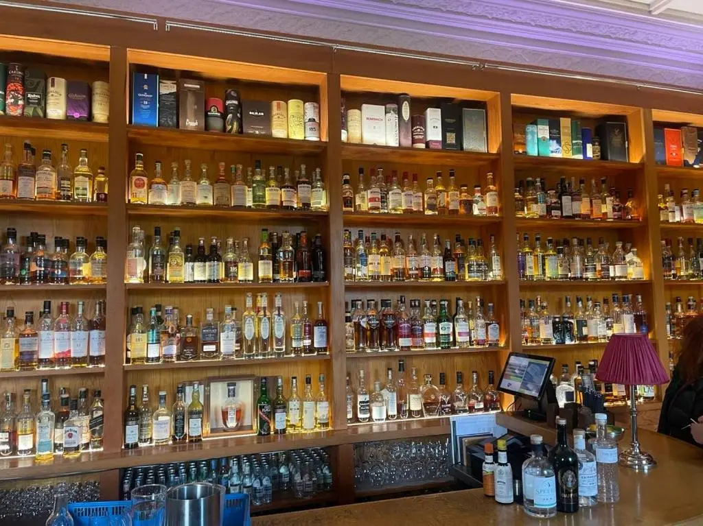 a room filled with lots of bottles of alcohol at Aberlour Apartment 92 B in Aberlour
