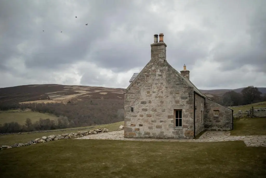an old stone building in the middle of a field at Inverenzie Cottage, Rooms with a view! in Coilacriech