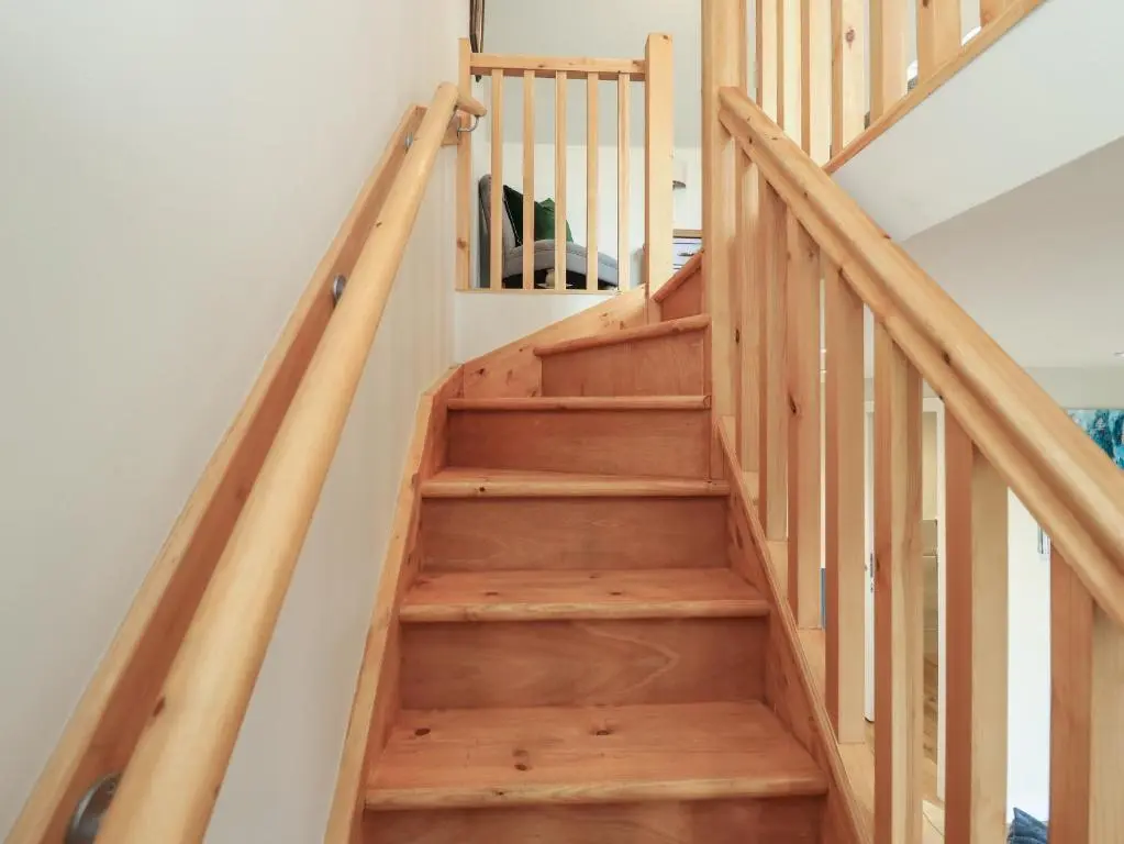 a staircase in a house with wooden steps at Wee Smithy in Munlochy