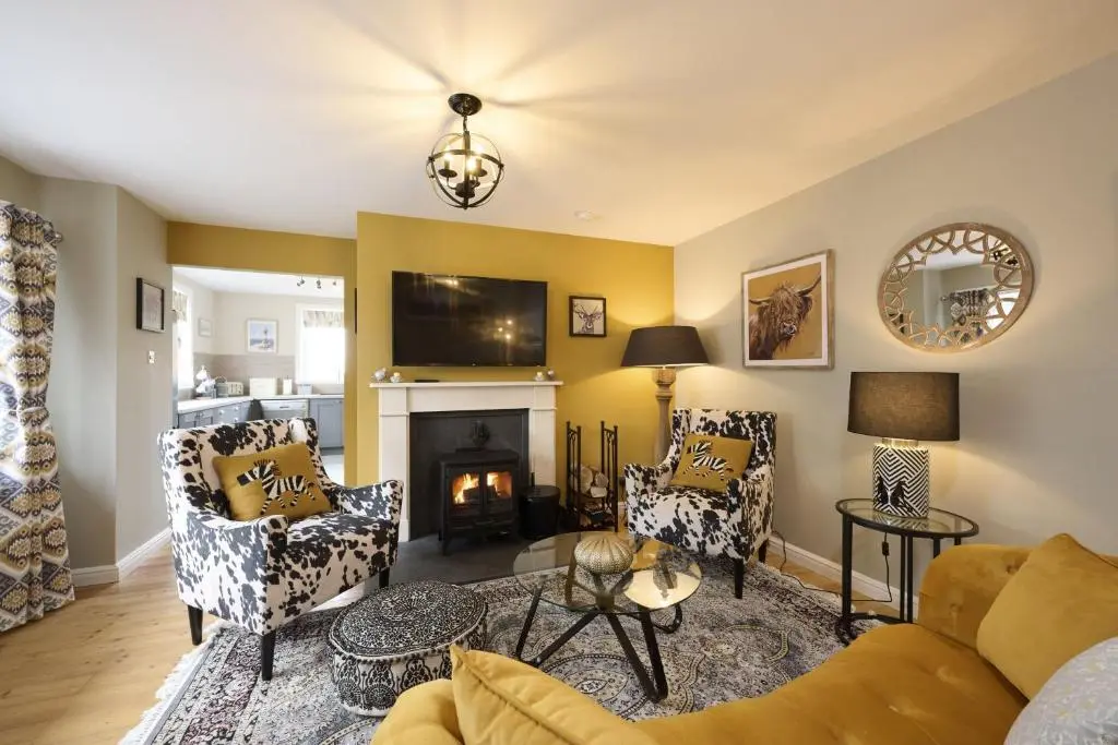 a living room with a couch and a fireplace at Glen View in Inverness