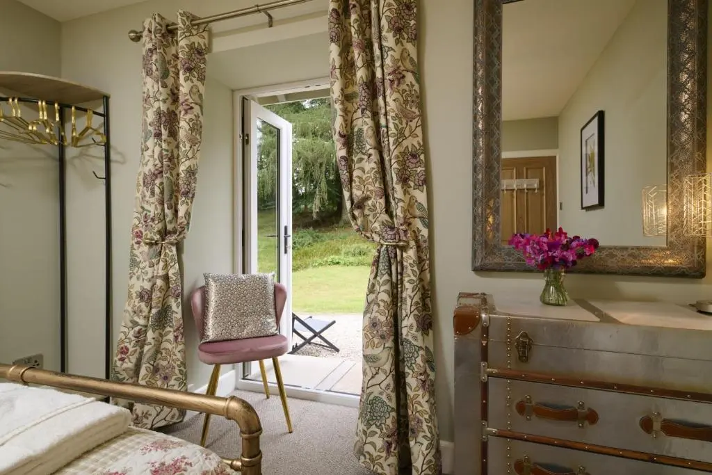 a bedroom with a bed and a mirror and a dresser at Upper Dunain in Inverness