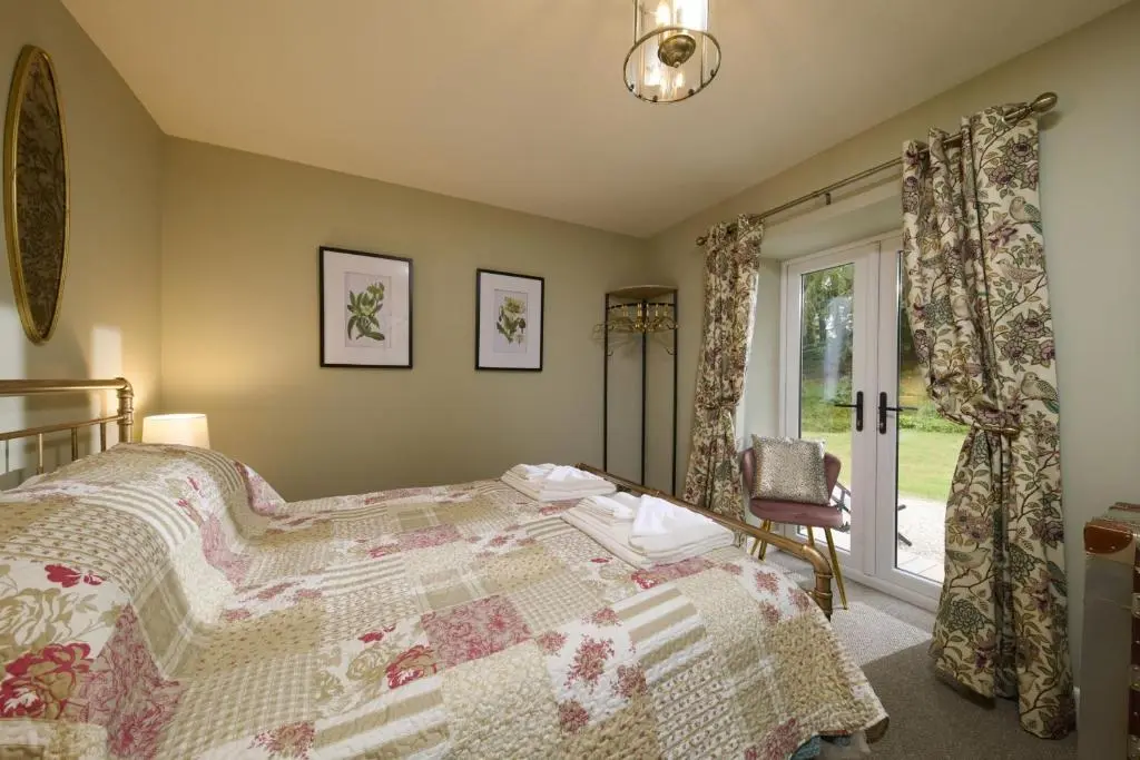 a bedroom with a bed and a window at Upper Dunain in Inverness