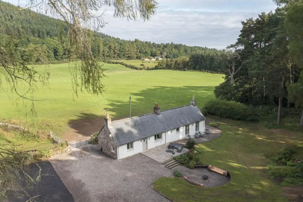 an aerial view of a house in a field at Upper Dunain in Inverness