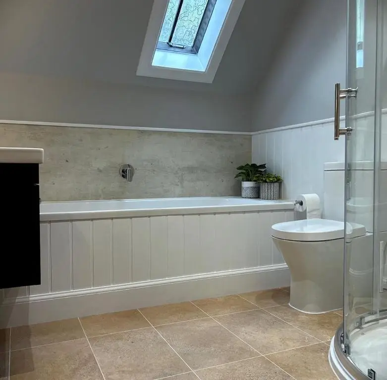 a bathroom with a tub and a toilet and a window at The Fiddich Luxury Home in Craigellachie in Craigellachie