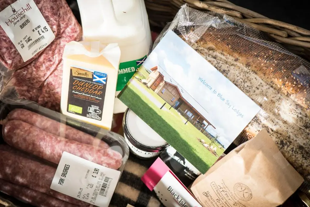 a basket of food with meat and other groceries at Atlas in Nairn