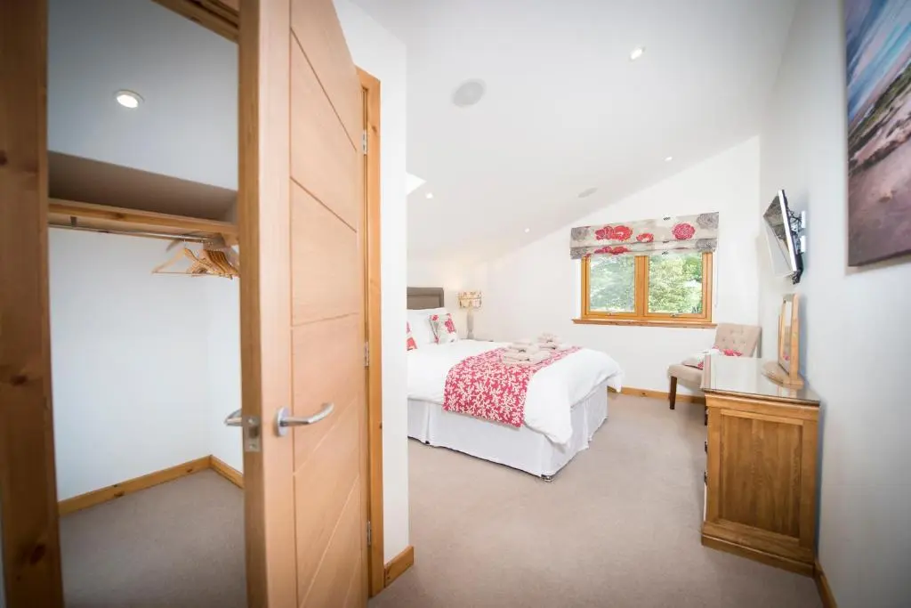 a bedroom with a bed and a window at Atlas in Nairn