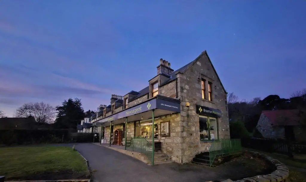 a large stone building with a store front at Bruachdryne Braemar Accommodation in Braemar