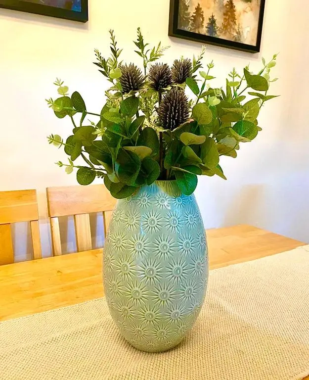 a blue vase with flowers in it on a table at Bruachdryne Braemar Accommodation in Braemar