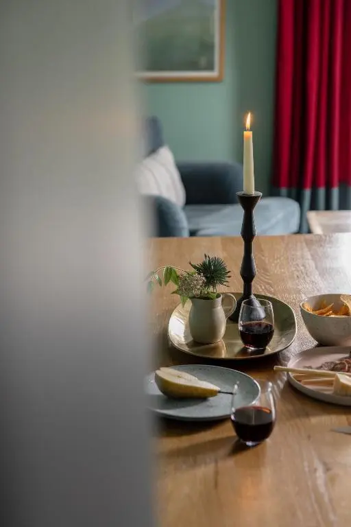 a table with plates and a candle on top of it at The Hayloft in Banchory