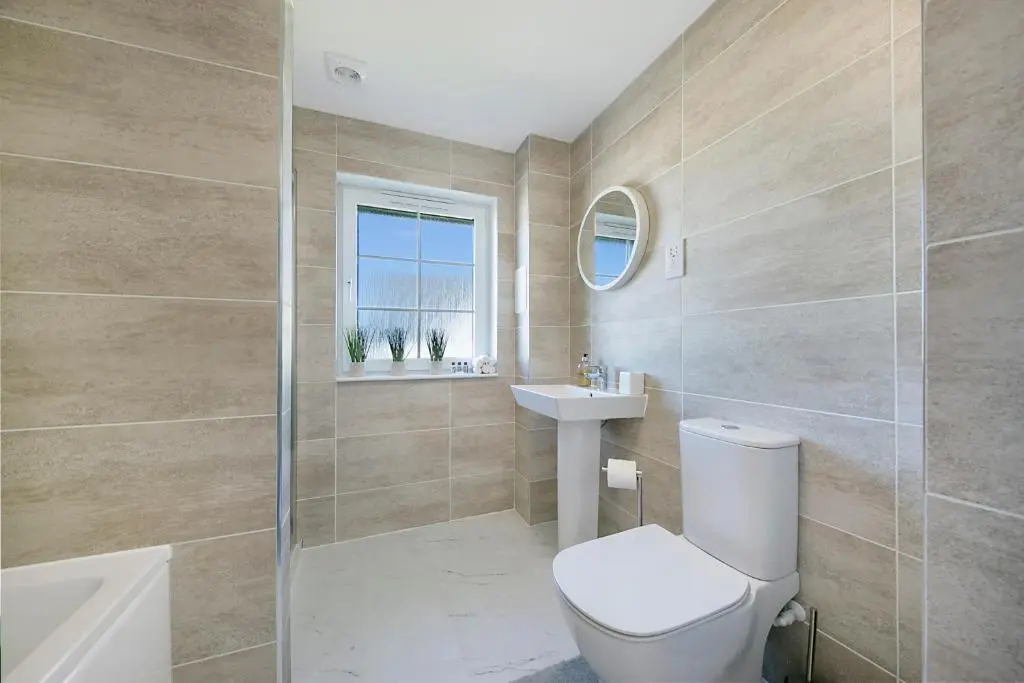 a bathroom with a toilet and a sink at Fern Place Villa - Grampian Lettings Ltd in West Cults